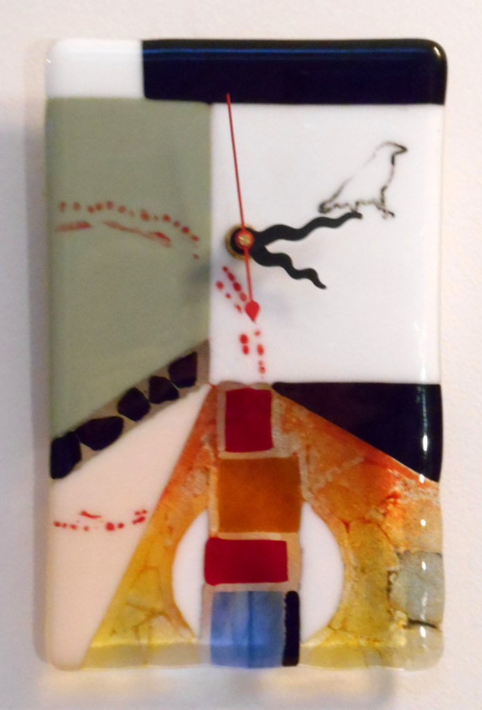 fused glass clock with white & green at top with raven walking off the clock. bottom is warm transparents.